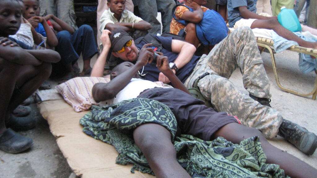 volunteer medic with patient in Haiti in 2010