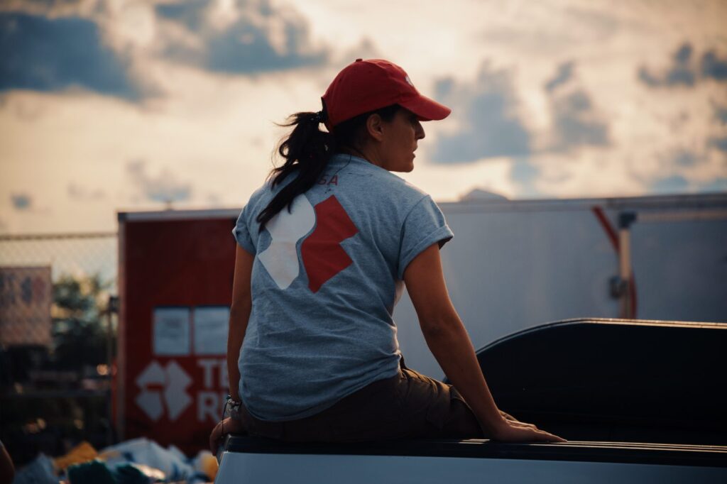 Woman sitting on pickup truck