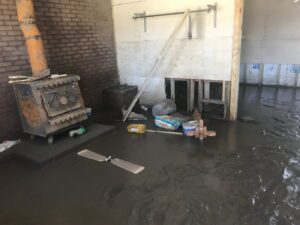 Cast iron stove in living room full of mud.