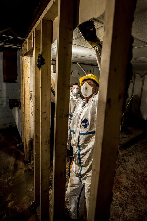 flood safety cleanup shows volunteer working in house