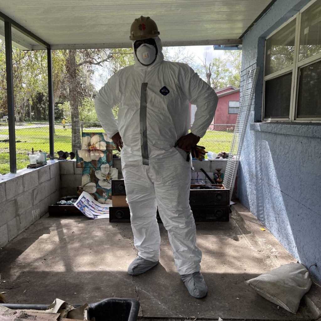 the power of volunteering author Maverick Johnson in hazmat suit