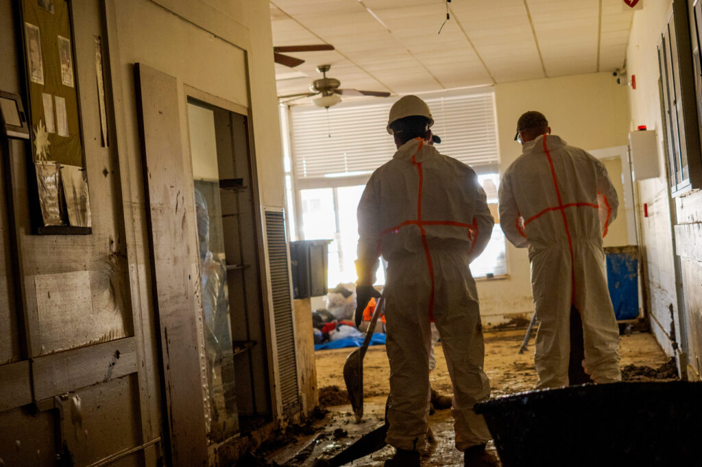 hurricane relief volunteers clean a home