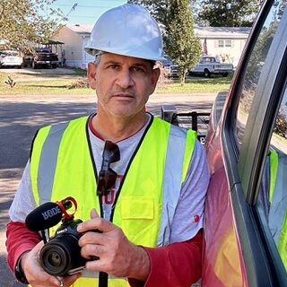 hurricane relief volunteer with camera