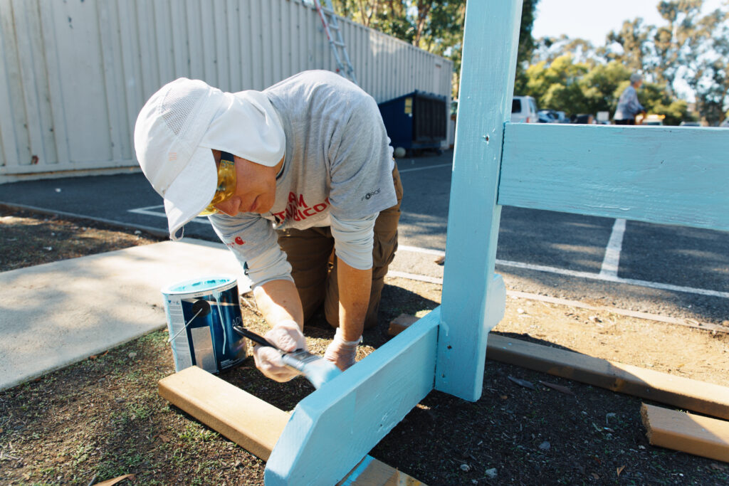 Painting a chair during a local community service project with the Huntington Beach Youth Shelter